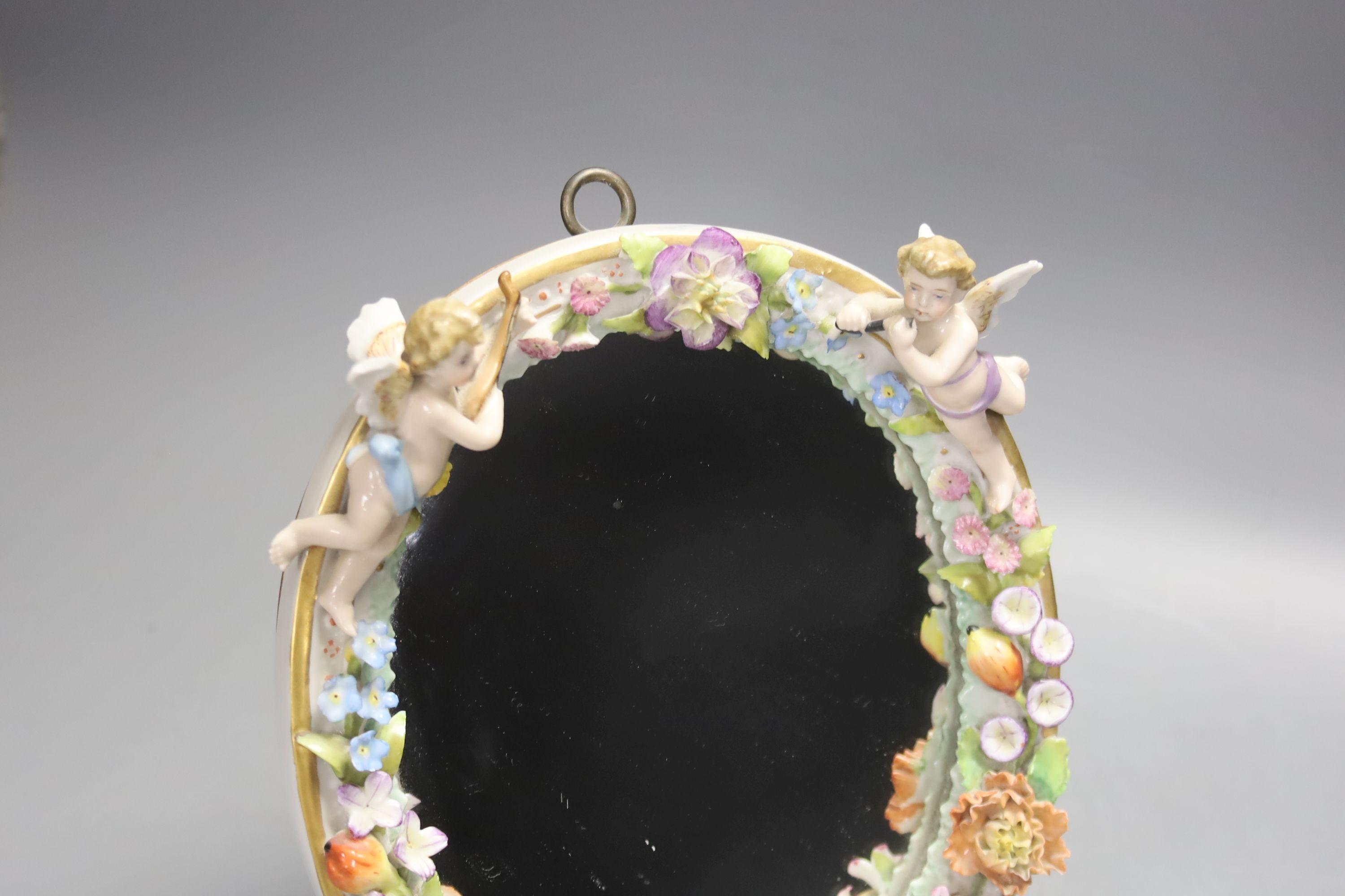 A 19th century Continental porcelain framed oval easel mirror, height 22cm